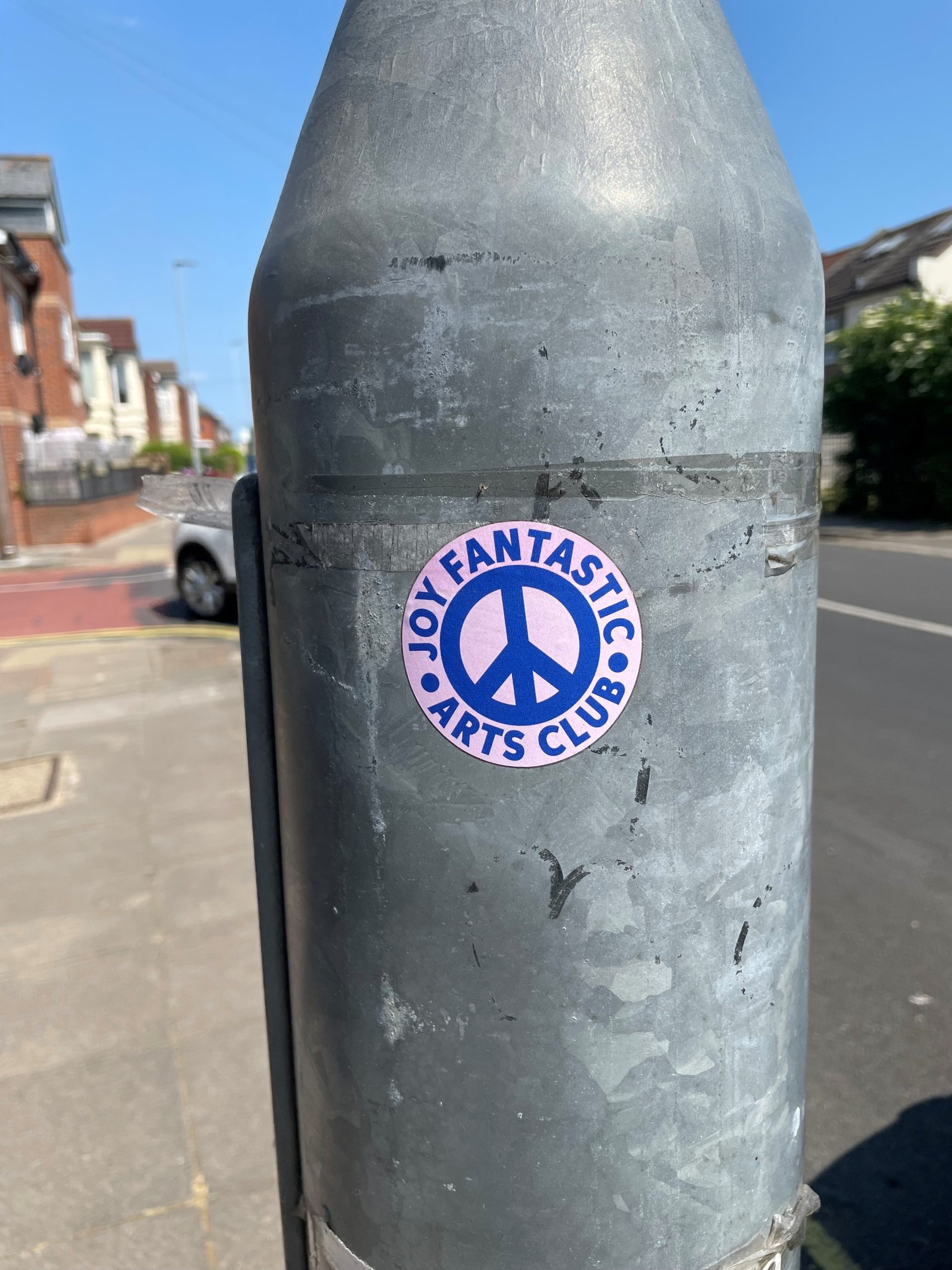Joy Fantastic arts club logo on lamp post