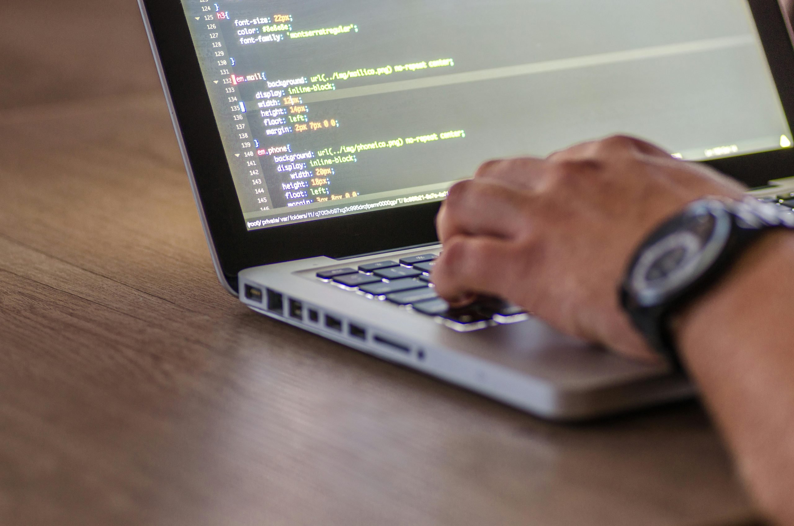 Man coding on a laptop