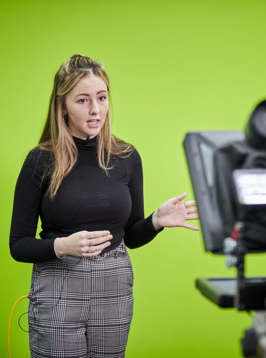 Solent-Growth-Partnership-Skills-Bootcamps - a woman in front of a green screen presenting in front of a camera