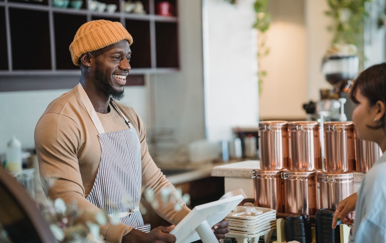 Small business owner at counter with a customer